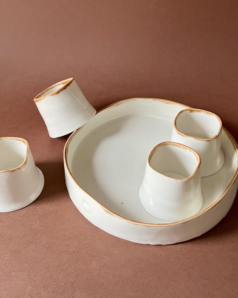 Set à café Ulysse liseré marron, tasses expresso posées dans et autour du plateau rond en porcelaine